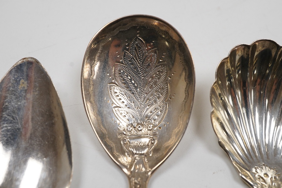 A George IV silver fiddle pattern caddy spoon, the bowl engraved with thistles, James Beebe, London, 1825, 90mm, a Georgian siler caddy spoon, the bowl embossed with urn and flowers, a late Victorian silver caddy spoon w